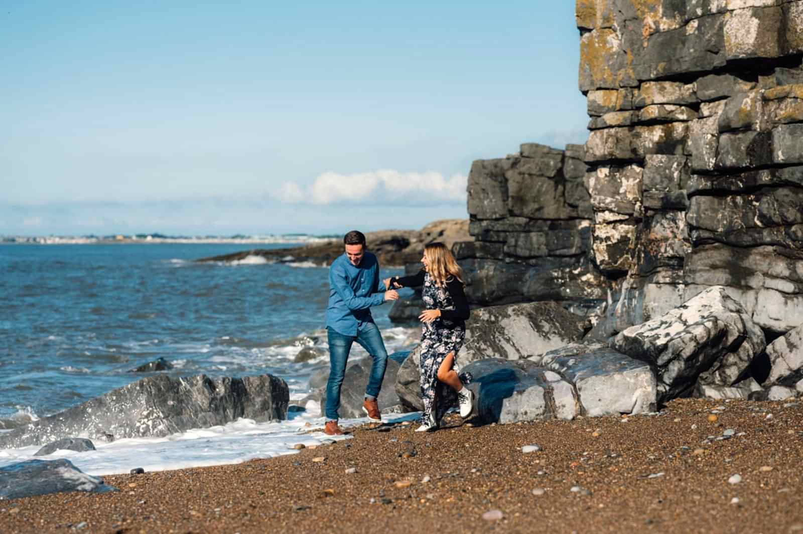 amy and nath runnign away from a big wave