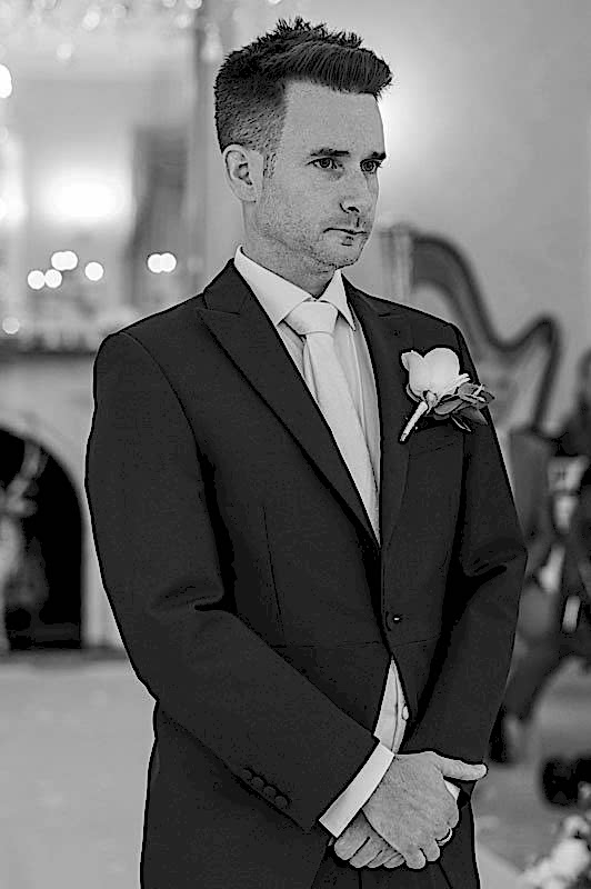 Groom at lakeside wedding venue