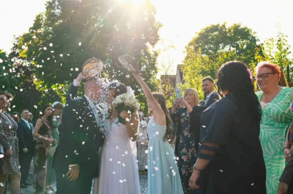Bride and groom wedding confetti moment in South Wales countryside
