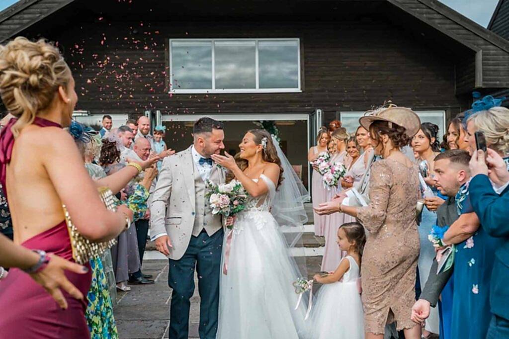 Bride and groom wedding confetti moment in South Wales countryside
