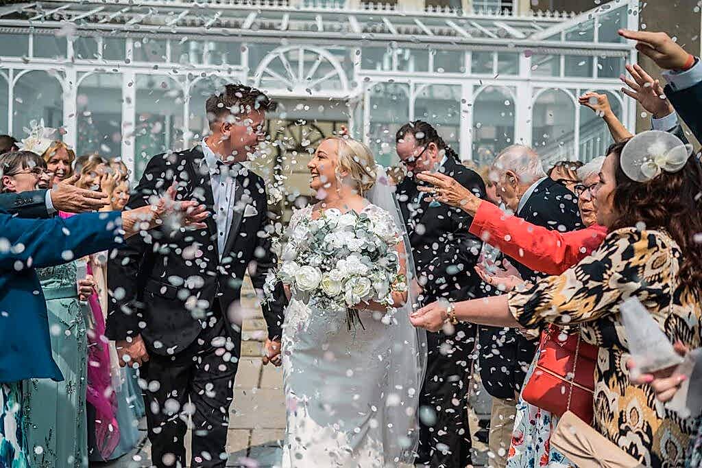 Bride and groom wedding confetti moment in South Wales countryside